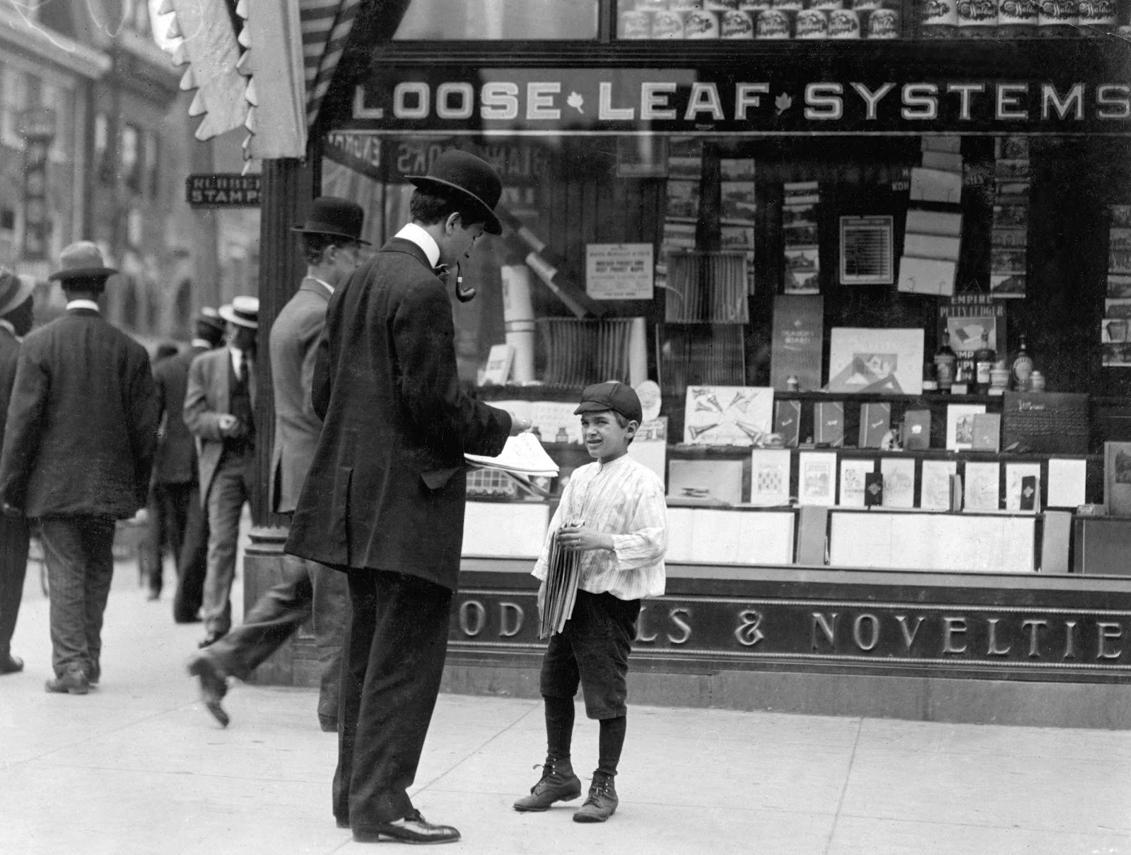 a newsboy selling a newspaper